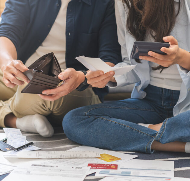 Stressed financial owe asian young couple love sitting stressed and confused by hand hold wallet calculate expense from invoice , no money to pay, mortgage or loan. Debt, bankrupt or bankruptcy people