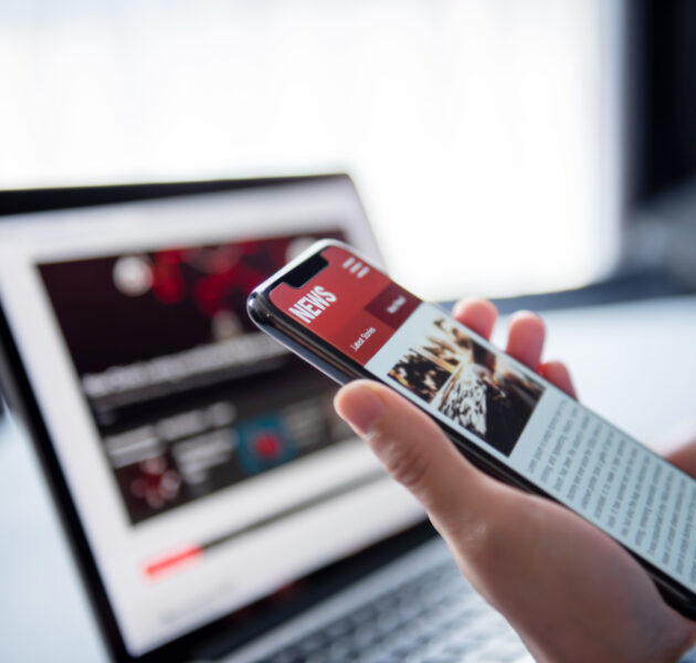 Online news on a smartphone and laptop. Mockup website. Woman re
